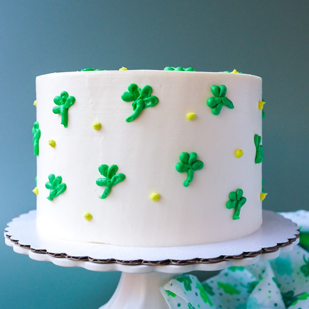 White cake decorated with green clovers