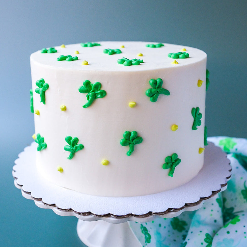 White cake decorated with green clovers