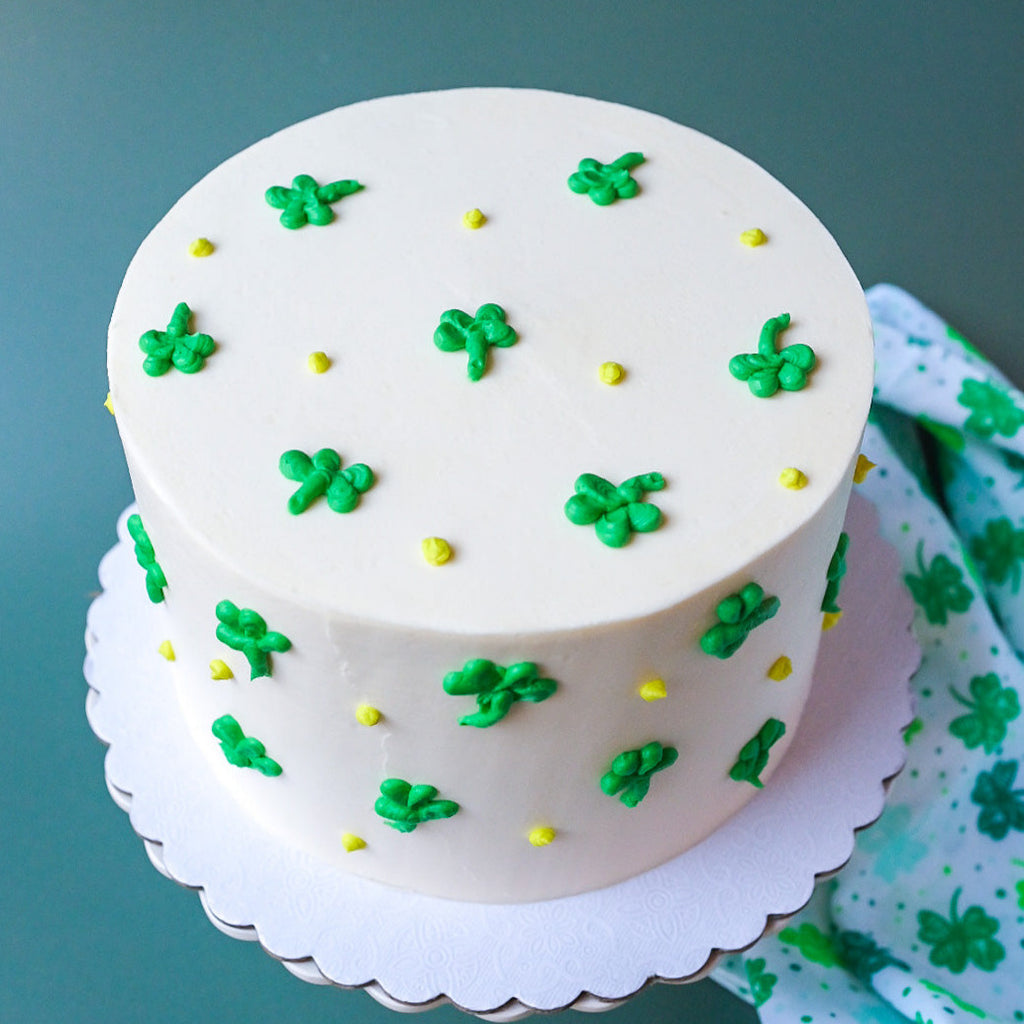 White cake decorated with green clovers